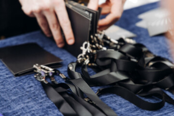 Plakat Checking in on conference congress forum event, registration desk table, visitors and attendees register electronic ticket and receiving black lanyard with name badge and entry wristband bracelet