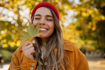 young attractive blond woman walking in autumn park, stylish , smiling