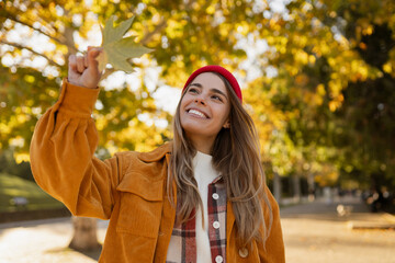 young attractive blond woman walking in autumn park, stylish , smiling