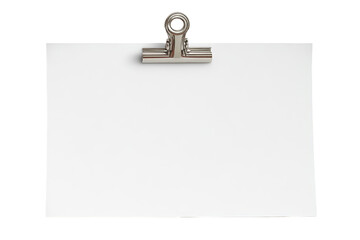 A single silver clip fastens a blank white note ready for a message or design isolated on a black background