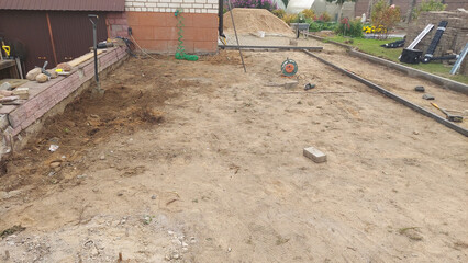 Construction site preparation in a residential backyard during the day