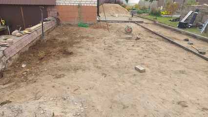 Fotobehang Beige Construction site preparation in a residential backyard during the day  © Сергей Семенов
