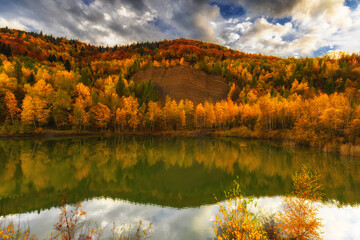 Autumn landscape in a quarry surrounded by colorful trees, Poland, Silesian Voivodeship