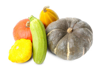 Many fresh pumpkins and other vegetables of gourd family isolated on white