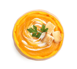 Tasty pumpkin cream soup with croutons and parsley in pumpkin isolated on white, top view
