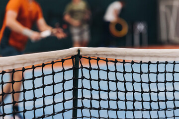 Tennis tournament championship on outdoor clay court with net, professional athletes play in motion...