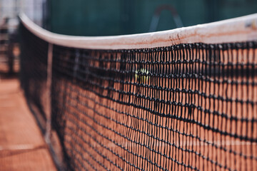 Tennis tournament championship on outdoor clay court with net, professional athletes play in motion with rackets serve tennis ball during tennis match game, tennis training in a sunny day on a stadium