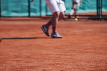 Tennis tournament championship on outdoor clay court with net, professional athletes play in motion with rackets serve tennis ball during tennis match game, tennis training in a sunny day on a stadium
