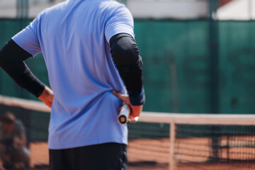 Tennis tournament championship on outdoor clay court with net, professional athletes play in motion with rackets serve tennis ball during tennis match game, tennis training in a sunny day on a stadium