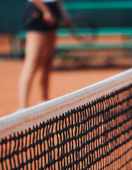 Tennis tournament championship on outdoor clay court with net, professional athletes play in motion with rackets serve tennis ball during tennis match game, tennis training in a sunny day on a stadium