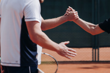 Tennis tournament championship on outdoor clay court with net, professional athletes play in motion with rackets serve tennis ball during tennis match game, tennis training in a sunny day on a stadium