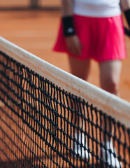 Tennis tournament championship on outdoor clay court with net, professional athletes play in motion with rackets serve tennis ball during tennis match game, tennis training in a sunny day on a stadium