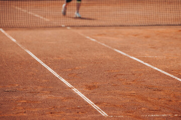 Tennis tournament championship on outdoor clay court with net, professional athletes play in motion with rackets serve tennis ball during tennis match game, tennis training in a sunny day on a stadium