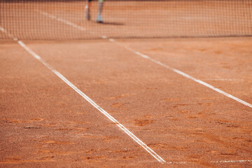Tennis tournament championship on outdoor clay court with net, professional athletes play in motion with rackets serve tennis ball during tennis match game, tennis training in a sunny day on a stadium