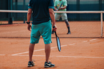 Tennis tournament championship on outdoor clay court with net, professional athletes play in motion with rackets serve tennis ball during tennis match game, tennis training in a sunny day on a stadium