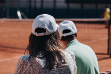 Tennis tournament championship on outdoor clay court with net, professional athletes play in motion with rackets serve tennis ball during tennis match game, tennis training in a sunny day on a stadium