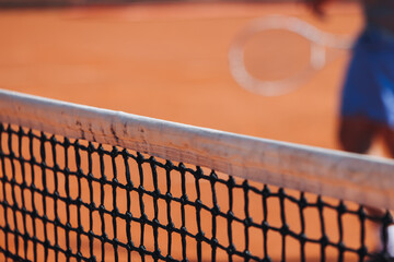 Tennis tournament championship on outdoor clay court with net, professional athletes play in motion...