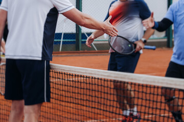 Tennis tournament championship on outdoor clay court with net, professional athletes play in motion with rackets serve tennis ball during tennis match game, tennis training in a sunny day on a stadium