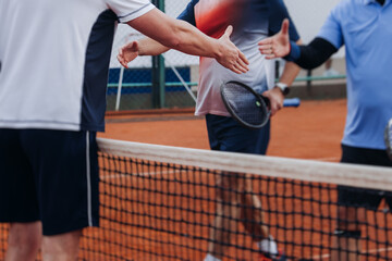 Tennis tournament championship on outdoor clay court with net, professional athletes play in motion with rackets serve tennis ball during tennis match game, tennis training in a sunny day on a stadium