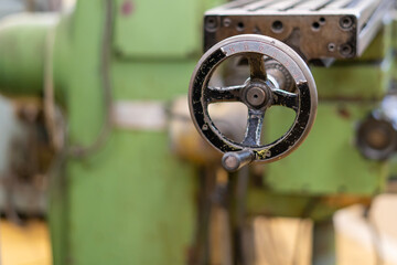 Old worn out milling machine control panel and control dial in a workshop