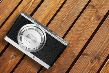 Old retro film camera on wooden desk