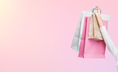 Young woman hold shopping bags on background.