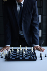 Naklejka premium Businessman playing chess game; business strategy, leadership and management concept.