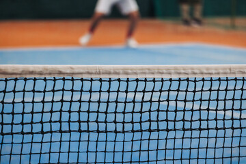 Tennis tournament championship on outdoor clay court with net, professional athletes play in motion...