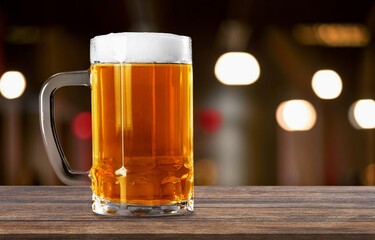 Cold mug of tasty fresh beer in a bar