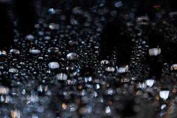 macro close-up of water droplets on a dark background. Mockup for your logo. horizontal wallpaper or web banner.
