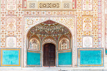 Stunning facade of Ganesh Pol entrance in Amber Fort Palace, Jaipur, Rajasthan, India.