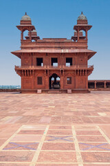 Diwan E Khas, also known as the Hall of Private Audiences, with an ornately carved central stone pillar, built for Emperor Akbar in Fatehpur Sikri, India.