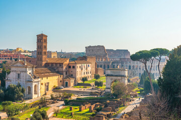 Naklejka premium Aerial view of ancient Colosseum Amphitheater in Rome city, Italy illuminated by soft morning light at sunrise. Italian architecture. Popular touristic and travel landmark