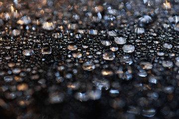 macro close-up of water droplets on a dark background. Mockup for your logo. horizontal wallpaper or web banner.