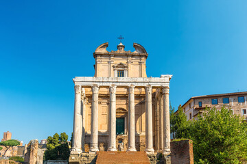 Ancient Roman temple facade with marble columns and baroque additions. Temple of Antoninus and Faustina, one of the most striking ancient ruins in Roman Forum in Rome, Italy. Touristic landmark