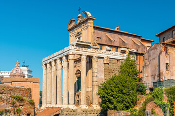 Temple of Antoninus and Faustina, one of the most striking ancient structures in Roman Forum in Rome, Italy. Ancient Roman temple ruins with tall marble columns and intricate carvings