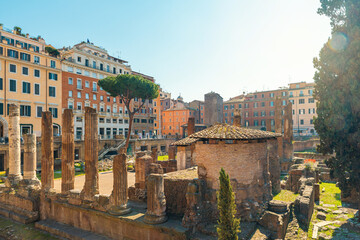 Largo di Torre Argentina in Rome, Italy. Roman square with ancient ruins of four Roman Republican temples and Pompey's Theatre surrounded by colorful buildings. Italian architecture