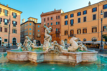 Fountain of Neptune at Piazza Navona with colorful historic buildings in Rome, Italy at sunrise. Fontana del Nettuno on Italian square with Roman architecture. Travel and touristic landmark