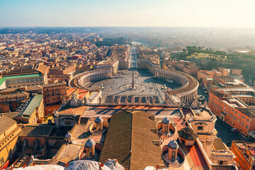 Aerial view of St. Peter's Square in Vatican City with Rome skyline in background on sunny day. Italian architecture. Travel landmark in Rome city, Italy. View on Piazza San Pietro from Basilica