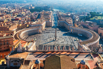 Aerial view of St. Peter's Square in Vatican City with central obelisk, colonnade and Italian architecture in ancient Rome city on background. Travel landmark in Italy. View on Piazza San Pietro