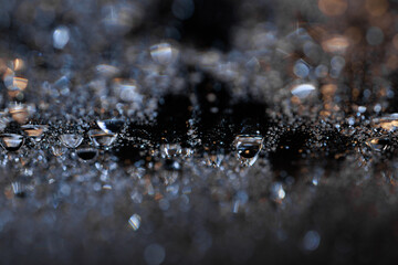 macro close-up of water droplets on a dark background. Mockup for your logo. horizontal wallpaper or web banner.