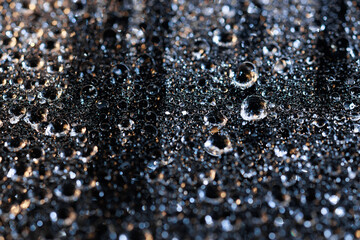 macro close-up of water droplets on a dark background. Mockup for your logo. horizontal wallpaper or web banner.