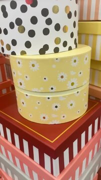 Gift wrapping materials including paper boxes. Decorative items prepared for packaging presents and festive occasions. Vertical video.