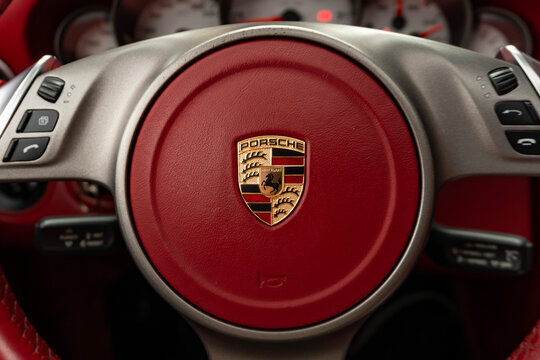 Porsche 911 steering wheel crest logo, red leather interior detail