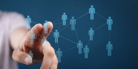 Hand pointing at connected digital human figures representing a network, collaboration, teamwork, and communication concepts, perfect for busine