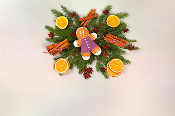 Beautiful holiday decoration made of live fir branches, cinnamon, dried oranges, star anise and...
