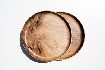 Empty wooden plate on white background