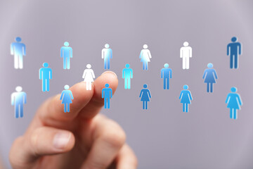 Hand interacting with digital human icons representing connection, teamwork, and networking in a...