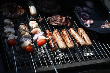 cooking on an open charcoal barbecue in the garden 