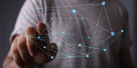 Close-up of a hand interacting with a digital network, symbolizing connection, technology, and...